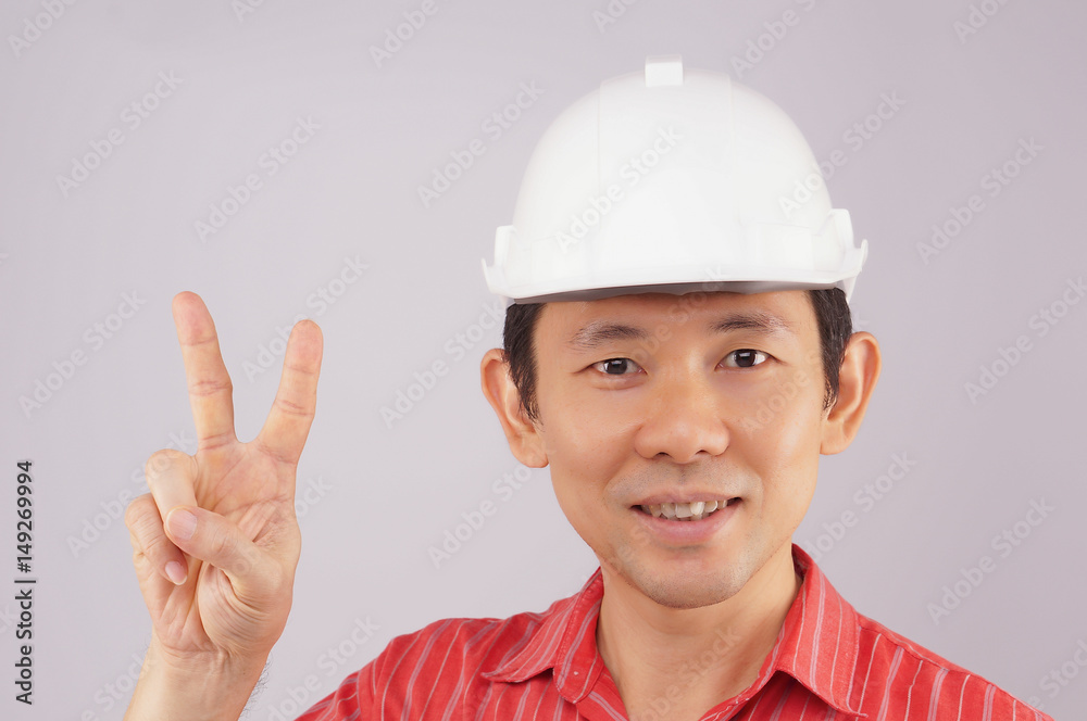 Engineer wear red shirt and white hat make signal victory Engineer wear red shirt and white hat make signal victory