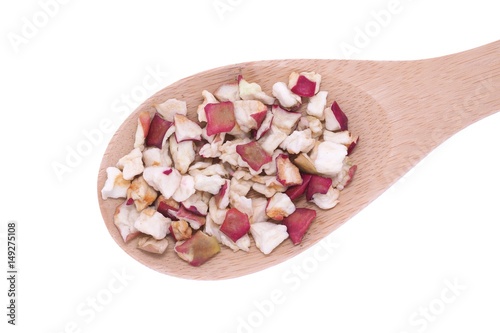 Dehydrated apple flakes in wooden spoon photo