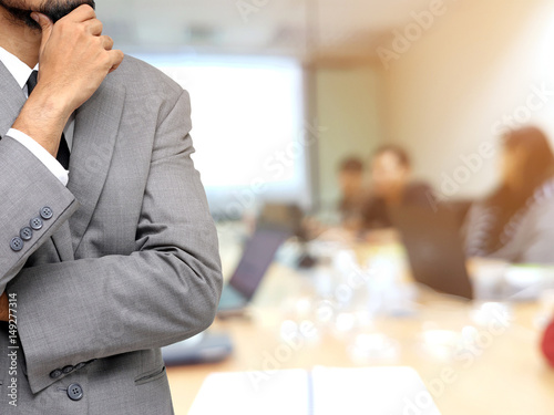business man thinking with meeting team background