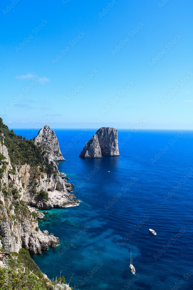 View of cliff coast of Capri Island with famous faraglioni