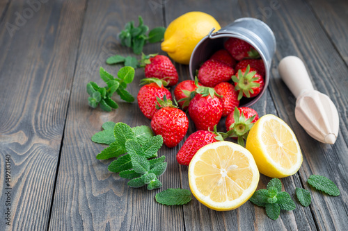 Ingredients for homemade strawberry lemonade on wooden table, copy space, horizontal