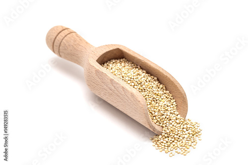 Wooden scoop with healthy quinoa seeds isolated on white