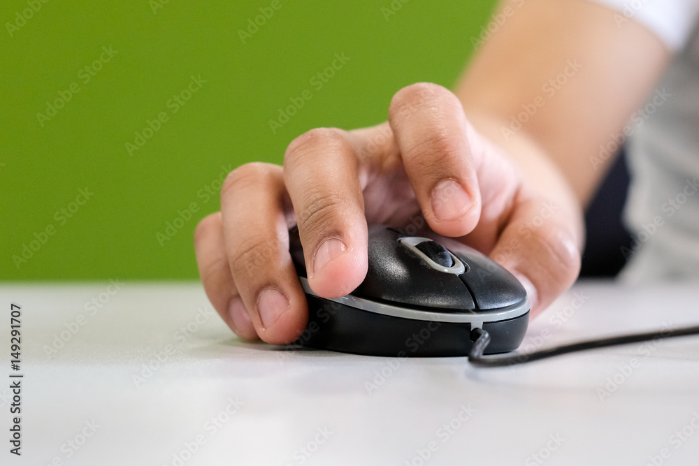 Man holding computer mouse in his hand, on the table Man holding computer mouse in his hand, on the table