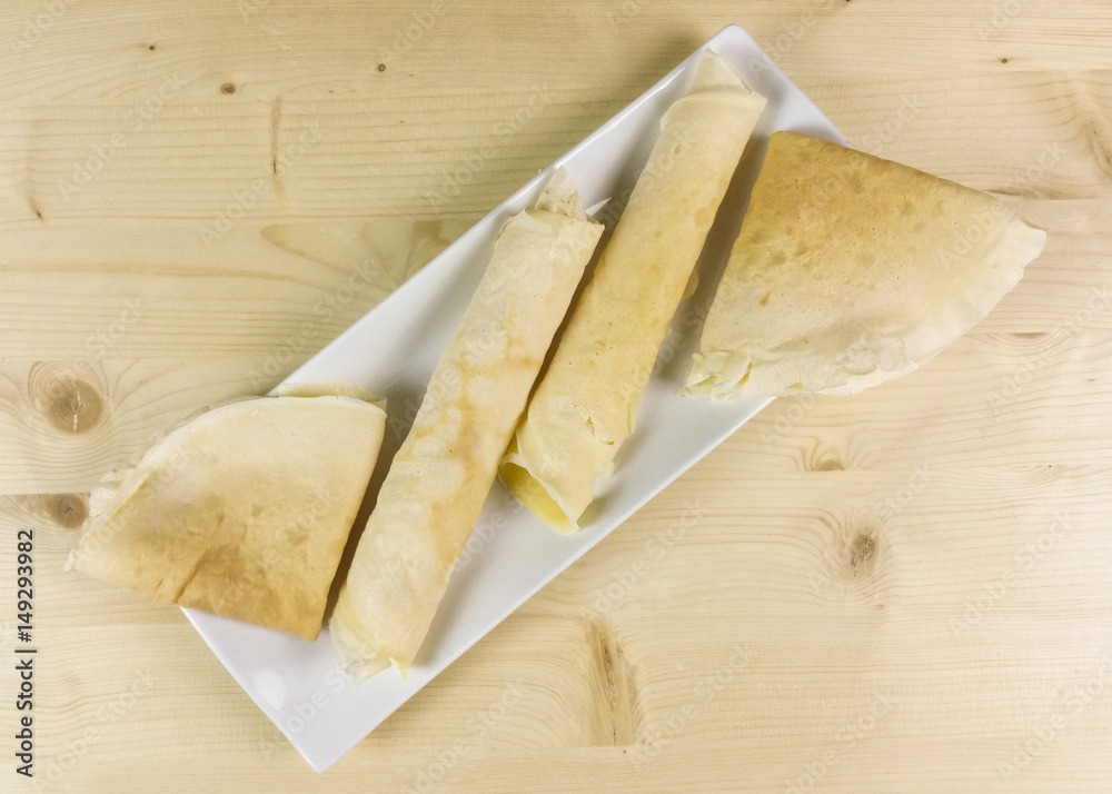 Crepes on wooden background - top view Crepes on wooden background - top view