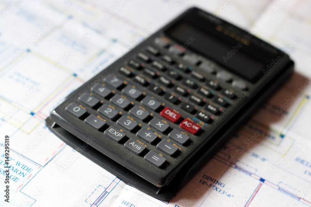 Calculator and building plans. Building planes for a new house, isolated. Calculator and building plans. Building planes for a new house, isolated.