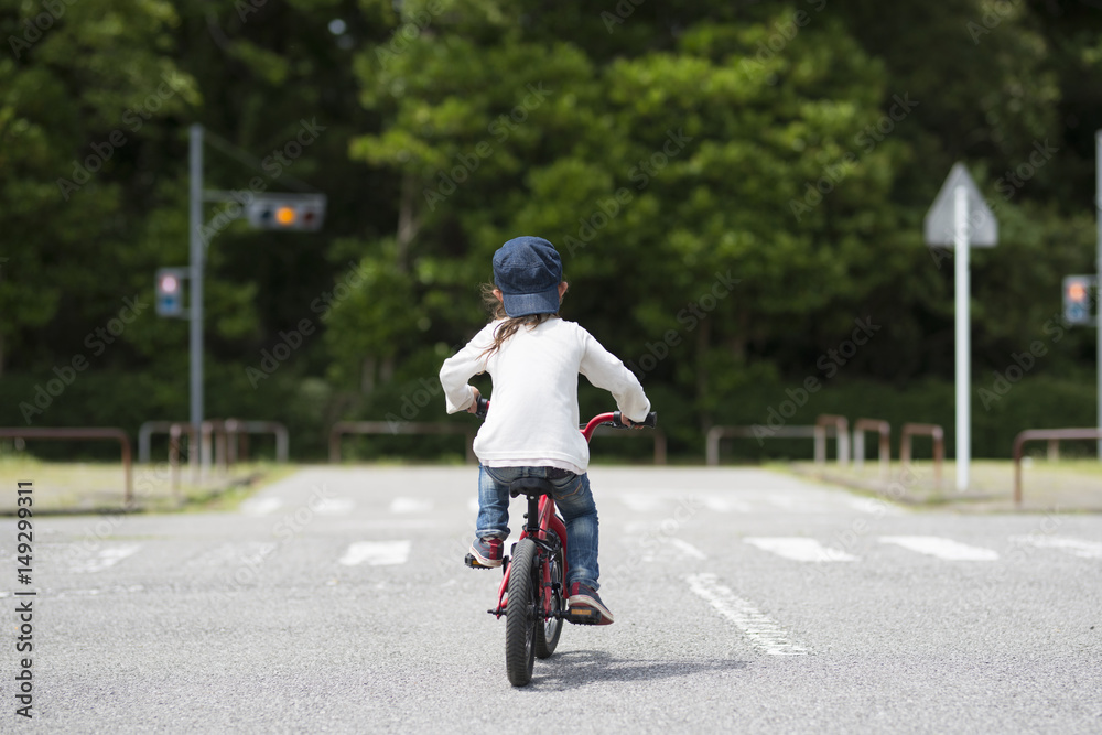 Obraz premium 赤い自転車に乗る女の子