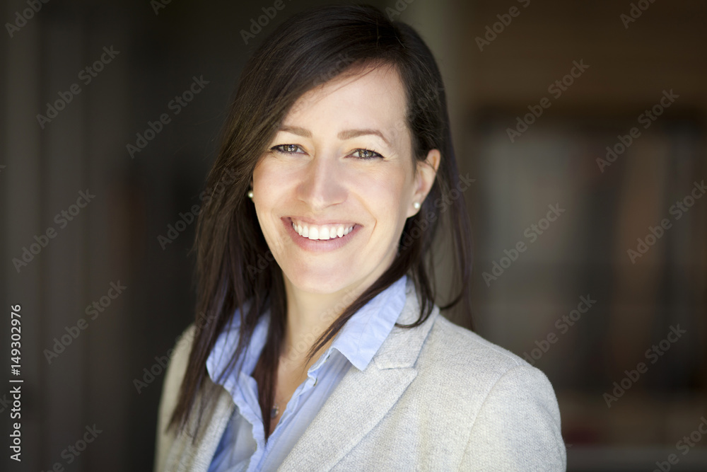 Mature Businesswoman Smiling At The Camera. Working At Home.