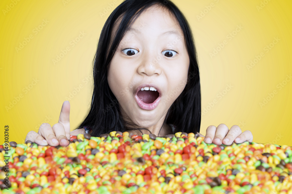 Little girl looking at colorful candies Little girl looking at colorful candies