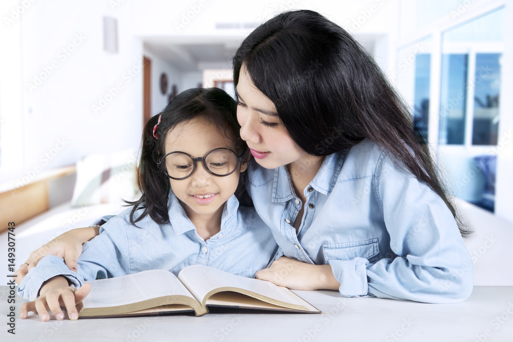 Mother teaching her daughter at home Mother teaching her daughter at home