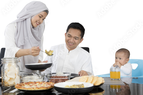Muslim family eating at dining table
