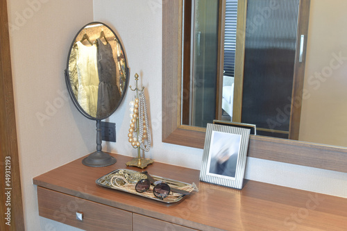 Photo female accessories on wooden dressing table at home