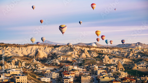 Hot air balloons flying over Cappadocia on sunrise