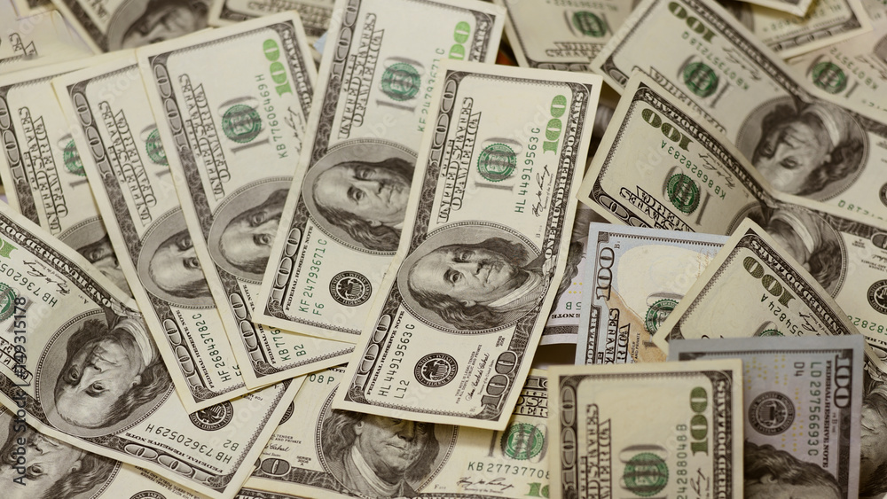 One hundred dollars pile as background. One hundred dollars pile as background.