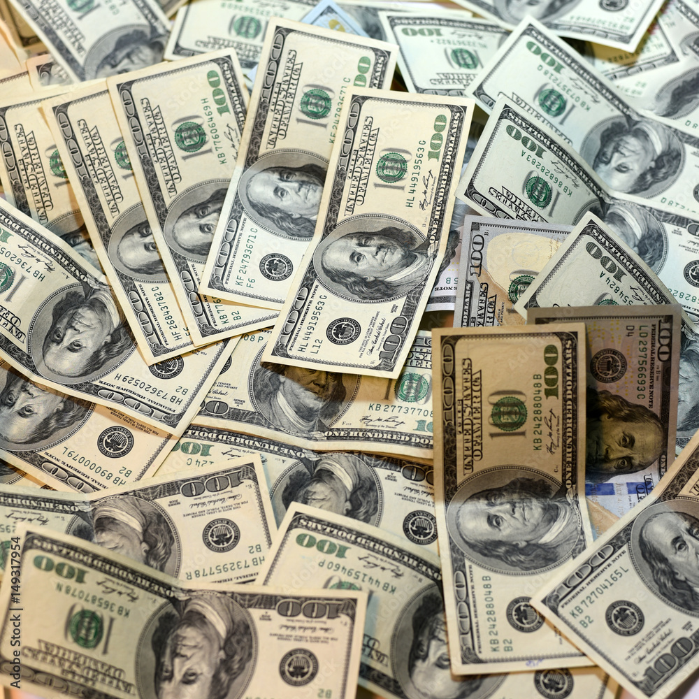 One hundred dollars pile as background. One hundred dollars pile as background.