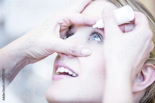 Person applying eye drops