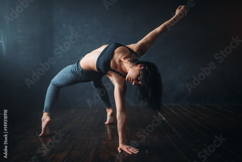 Flexible woman dancing in studio