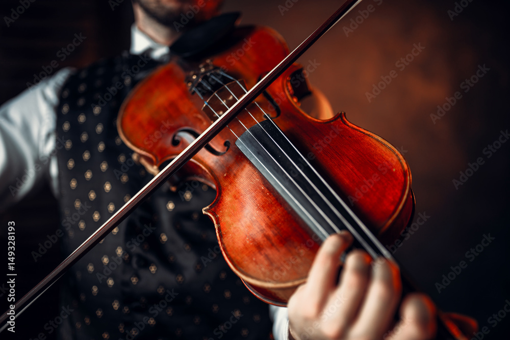Male violinist playing classical music on violin Male violinist playing classical music on violin