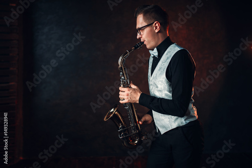 Male saxophonist playing classical jazz on sax