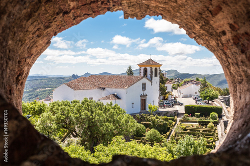 Church of portuguese town of Marvão seen through a hole photo