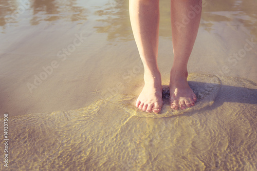 Photos Human leg on the beach with vintage style.