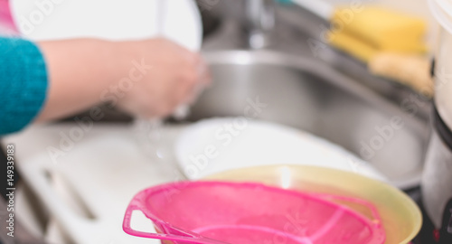 Close up of the hand doing dishes