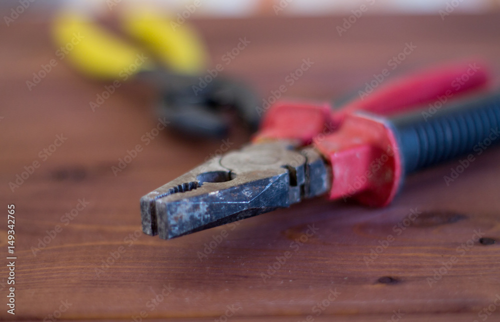 Tools on a wooden background. Pliers Tools on a wooden background. Pliers