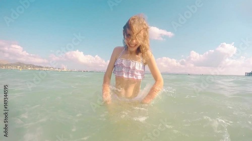 Little girl having fun in the sea.