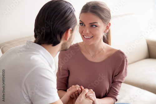 Obraz na plátně Portrait of beautiful excited woman looking at her boyfriend with affection whil