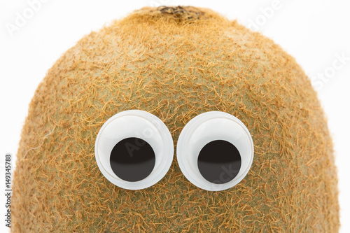 kiwi face with googly eyes on white background 