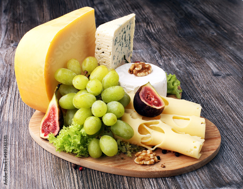 Fototapeta Naklejka Na Ścianę i Meble -  Cheese platter with different cheese and grapes