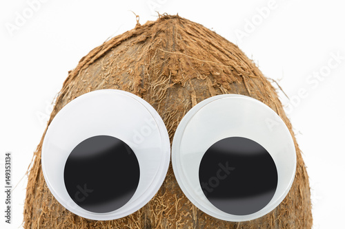 coconut with googly eyes on white background 