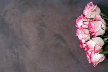 Pink roses on vintage rusty background with copy space for text. Top view, copy space. Concept of Mother's day, Women's day, Valentine's day card