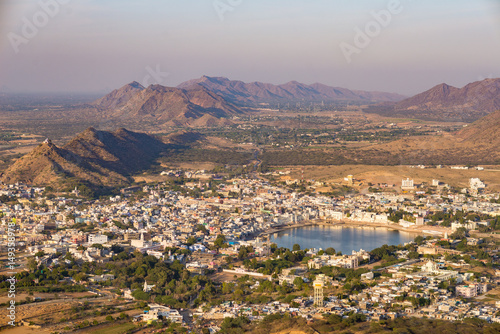 Aerial view of Pushkar, the town with the holy lake and the surrounding hills and rural landscape. Travel destination in Rajasthan, India.