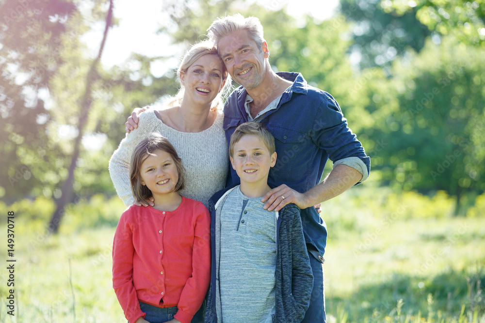 Cheerful family walking in park on sunny day Cheerful family walking in park on sunny day