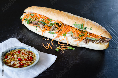 Vietnamese Pork Banh Mi Sandwich with Cilantro and carrot close-up