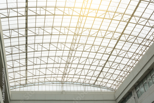 structural steel frame inside arched roof with evening sunlight