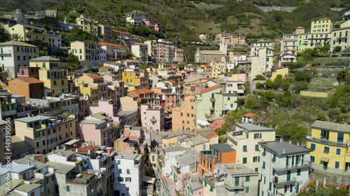 Aerial video footage with drone on Riomaggiore, one of the famous Cinqueterre country, small village with colored houses on the cliff over the sea