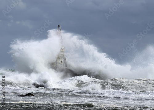 Winter storm. wave is shattering in the lighthouse. Ahtopol, Bulgaria Black Sea 