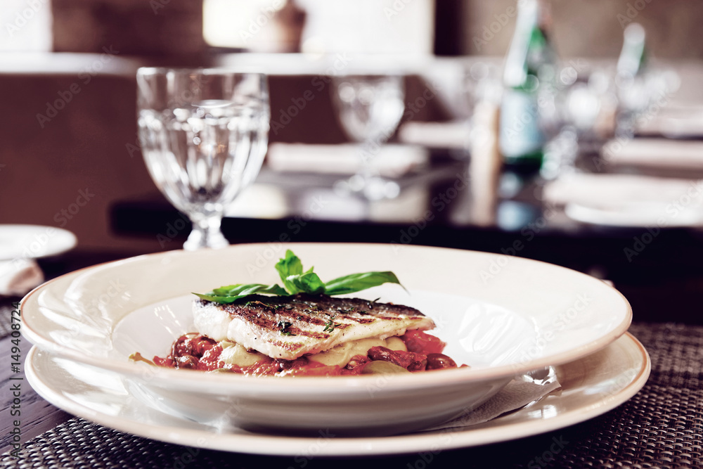 Sea bass fillet with tomato sauce and capers, toned