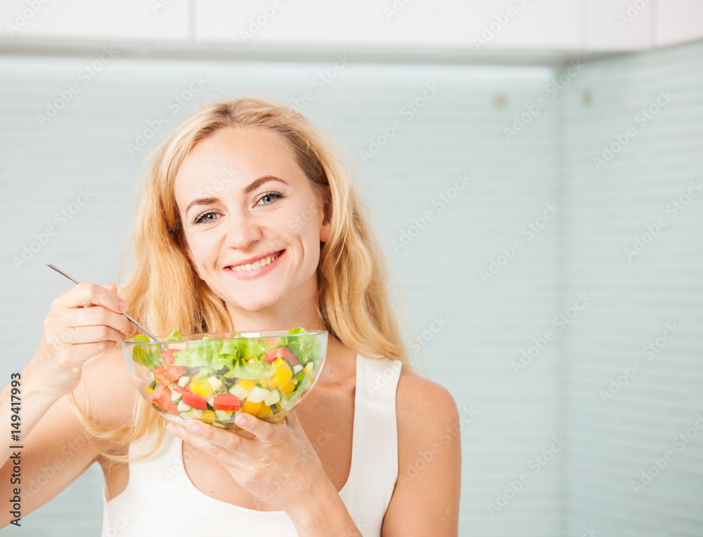Young woman eating vegetable salad Young woman eating vegetable salad
