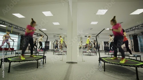 jumping fitness, skyjumping, sky jumping, big jumping, beautiful young girls doing jumping fitness. fitness on trampolines, young girls perform various exercises for a beautiful figure.