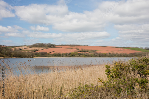 The red fields and freshwater lake at Slapton south Devon England