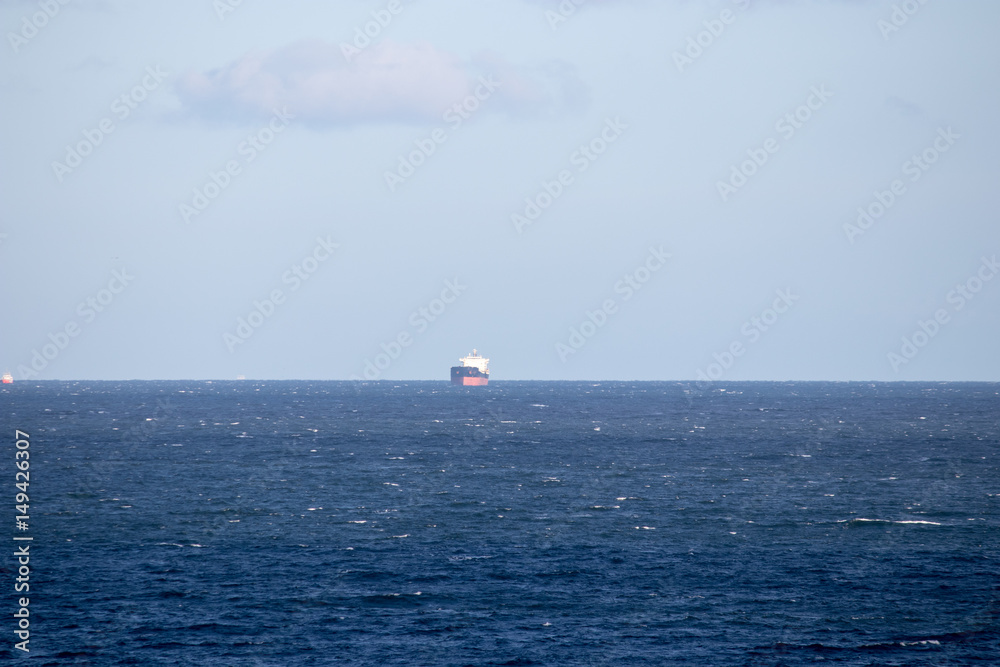Large oil tanker in the distance. Open sea. Large oil tanker in the distance. Open sea.