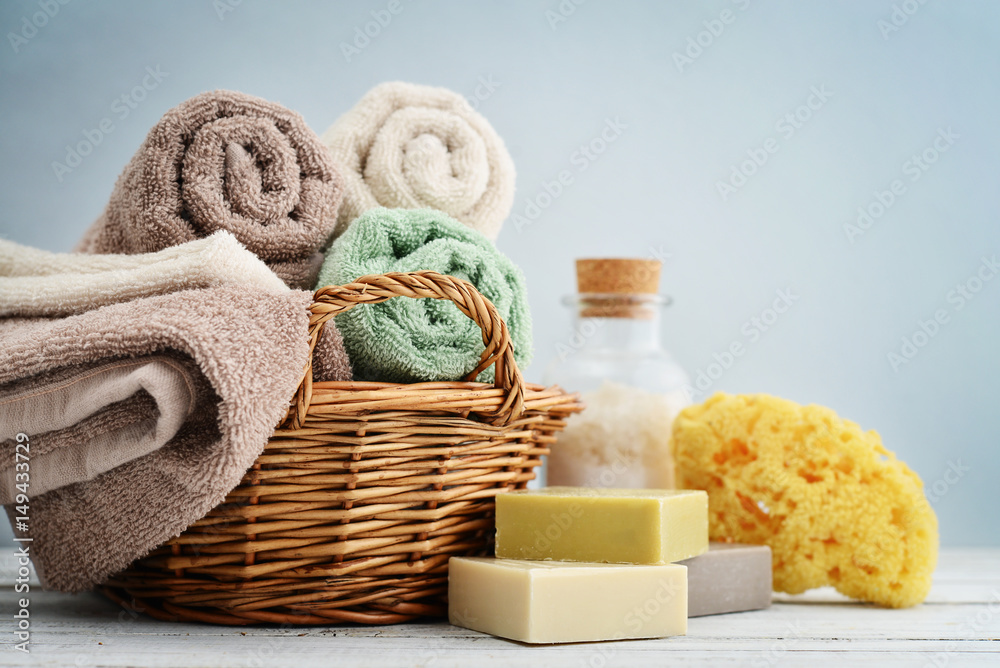 Bath towels of different colors in wicker basket Bath towels of different colors in wicker basket
