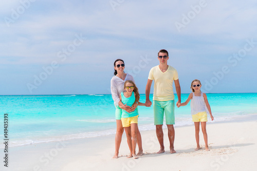 Family of four on a tropical beach