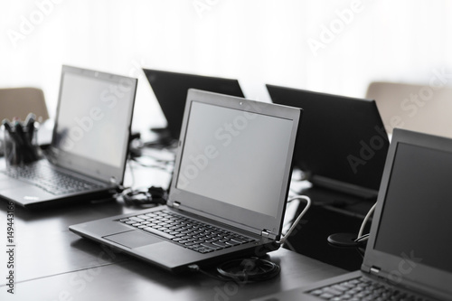 Modern conference room with furniture, laptops, big windows. office or training center interior. Computer Lab