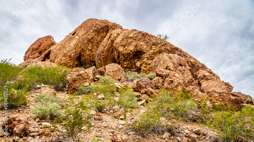 The red sandstone buttes of Papago Park, with its many caves and crevasses caused by erosion under cloudy sky, in the city of Tempe, Arizona in the United States of America