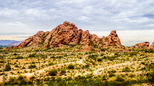 The red sandstone buttes of Papago Park, with its many caves and crevasses caused by erosion under cloudy sky, in the city of Tempe, Arizona in the United States of America photo