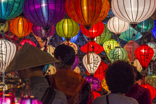 Tourists explore the old street of Hoi An Ancient Town with colorful lanterns, Quang Nam Province, Vietnam. UNESCO World Heritage Site photo