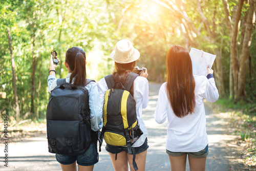 Group of beautiful young women walking in the forest, enjoying vacation, travel concept